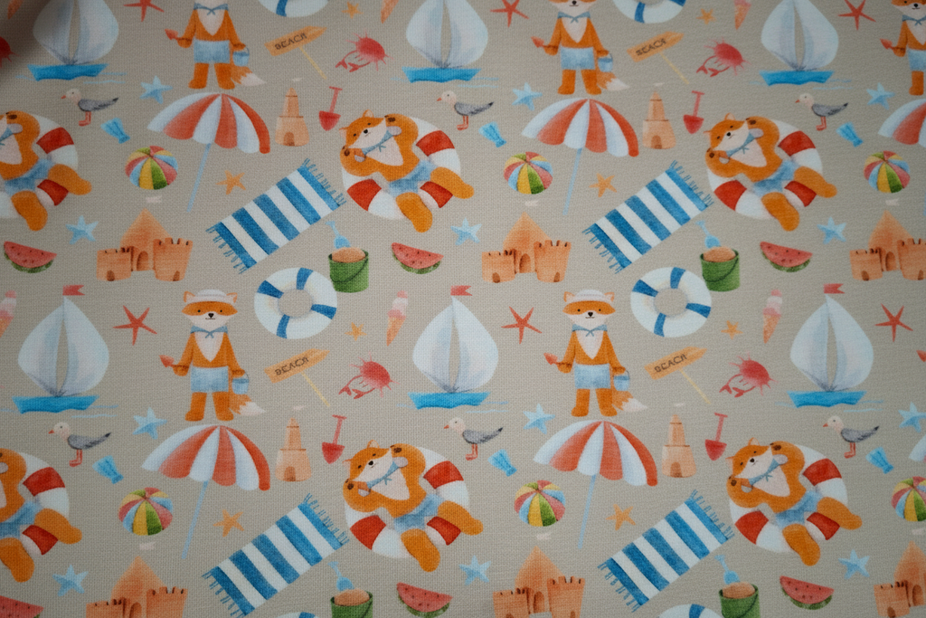 Patterned fabric with cartoon characters, boats, and beach items on a beige background