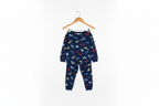 A two-piece children's pajama set hanging on a wooden hanger against a plain white background. The set consists of a long-sleeve top and matching pants in navy blue, covered in a playful print of small cars in red, yellow, and light blue.