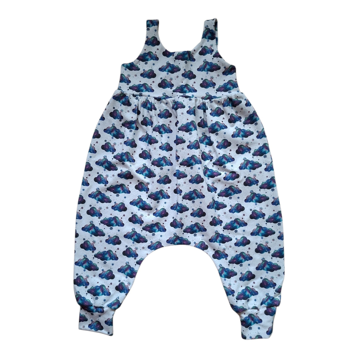 A baby romper with a white base and an all-over blue cloud pattern, featuring a high neckline and elastic leg cuffs.