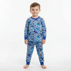 Child wearing blue dinosaur pajamas on a white background
