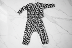 Children's outfit with black and white pattern on a white background