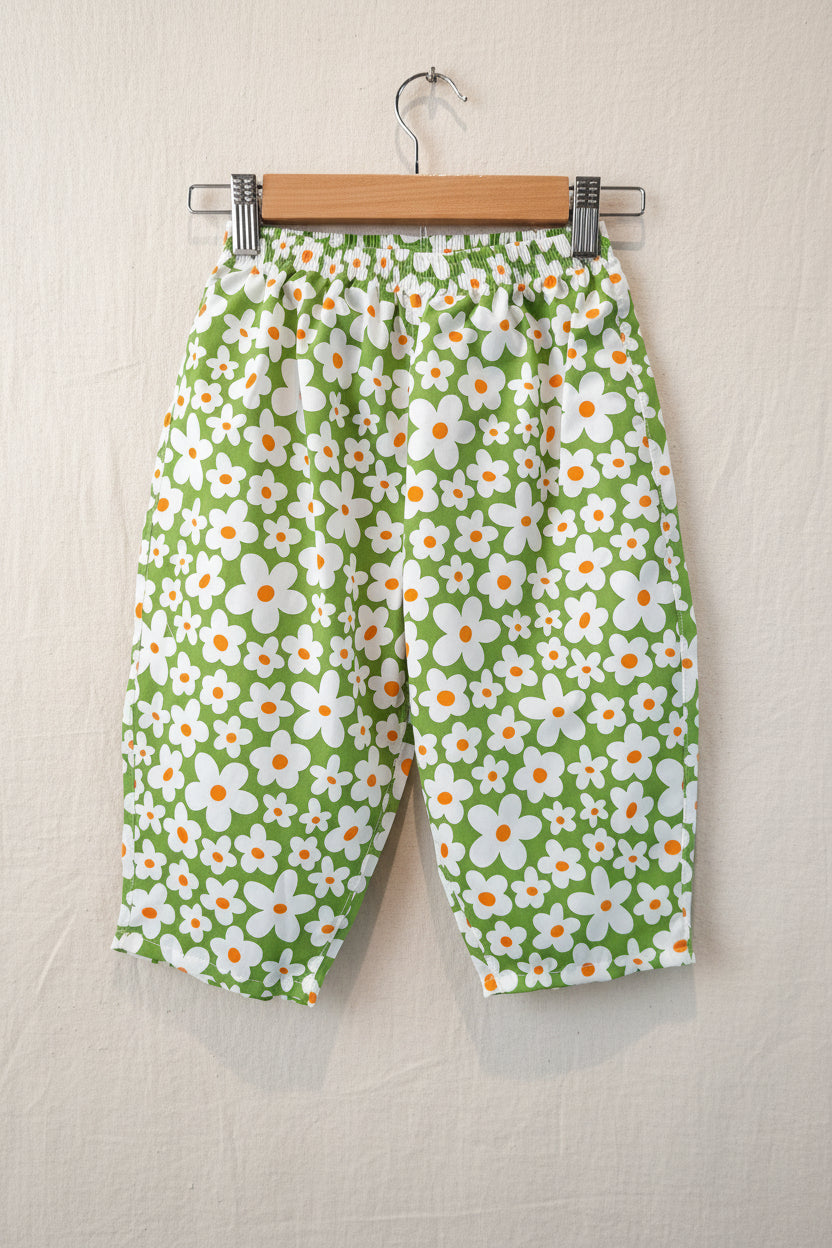 Green fabric with white floral pattern on a black background Snazzy Sproglets