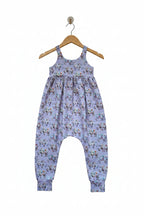 A baby romper in light lavender with an all-over colorful cartoon animal print, featuring a gathered waist and elastic ankle cuffs.