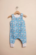 A light blue baby romper with a snowman print, hanging on a wooden hanger 