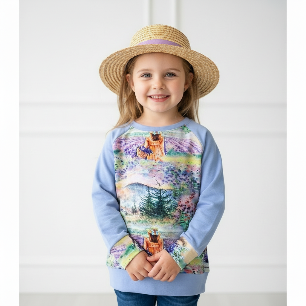 Child wearing a colorful sweater with a nature design and a straw hat on a white background