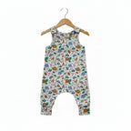 A sleeveless baby romper with an all-over safari animal print featuring sloths, monkeys, elephants, and leaves on a white background.snazzy sproglets