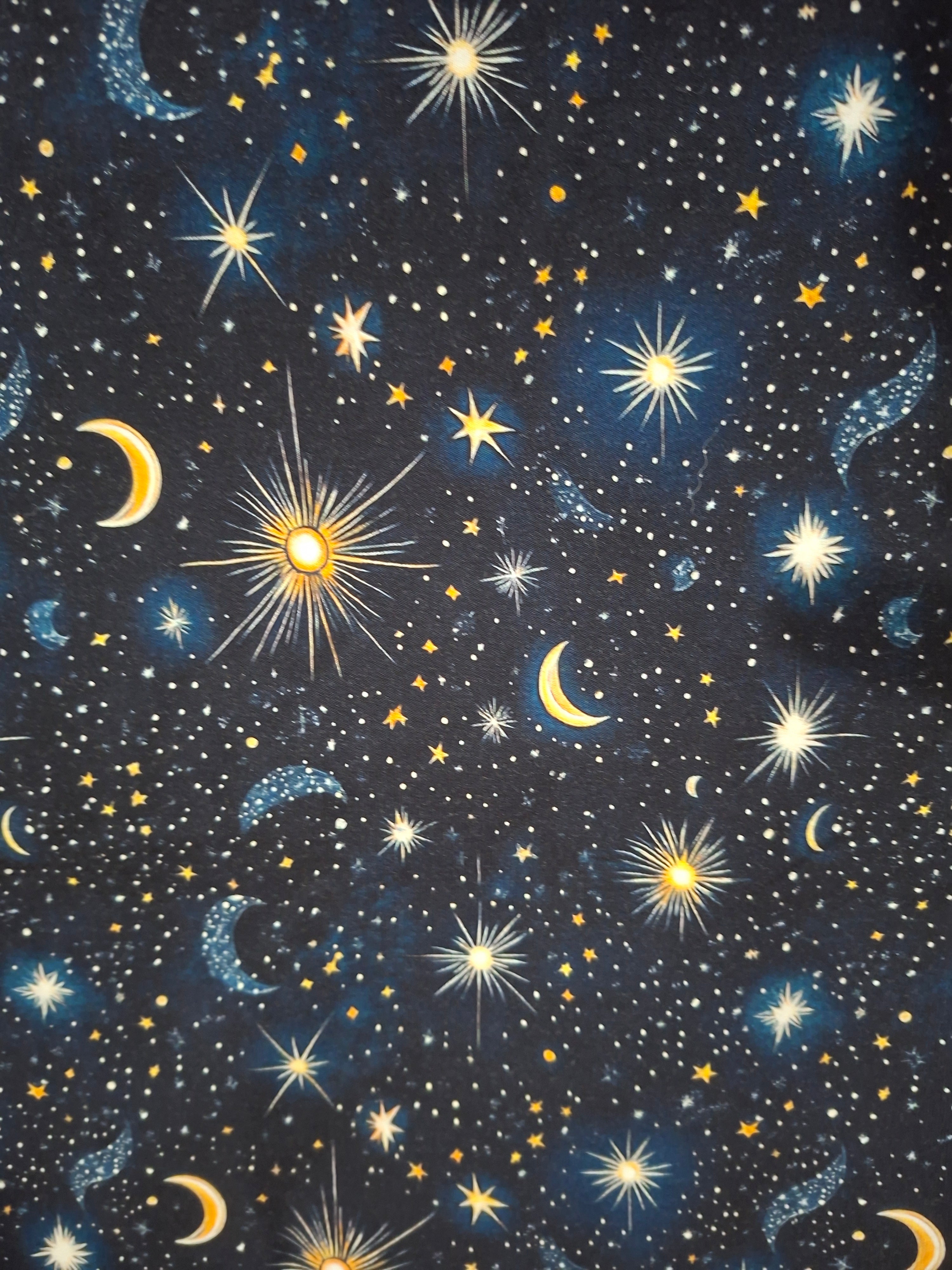 Starry night sky pattern with stars, moons, and suns on a black background