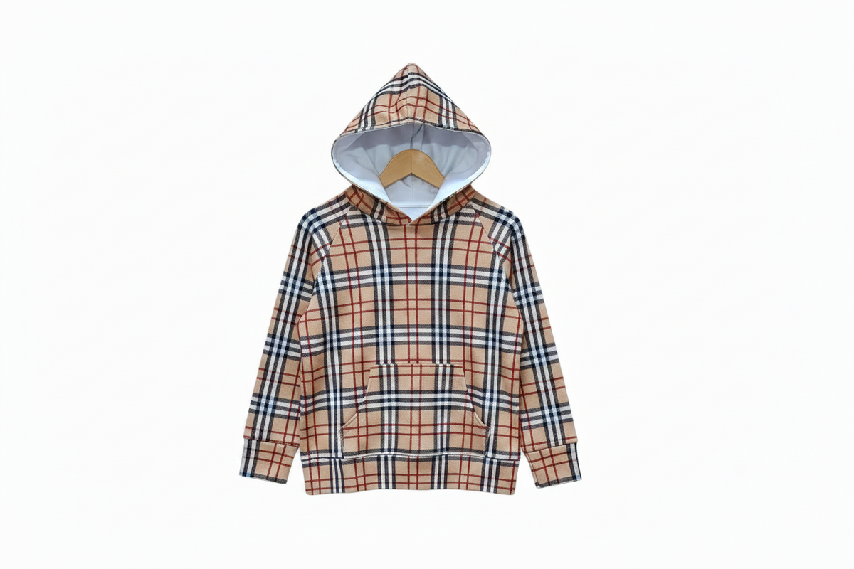 A hooded sweatshirt with a beige, red, and navy blue plaid pattern, featuring a white  lining inside the hood displayed on a wooden hanger against a white background.