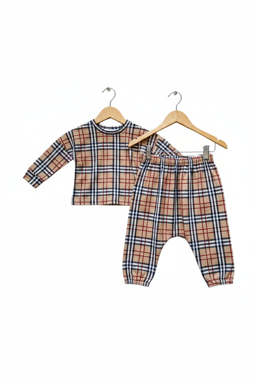 A two-piece children's plaid outfit set consisting of a long-sleeve crop top and matching jogger pants, featuring a classic check pattern in beige, red, navy, and white on a plain white background.