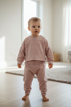 Child wearing the pink-and-white set
