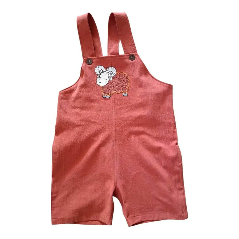 A baby's short overall romper in a dusty terracotta rust color, featuring adjustable shoulder straps with metal buttons and a cute cartoon sheep graphic on the chest.