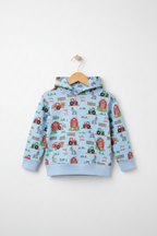 A light blue children's hooded sweatshirt with a colorful farm-themed print featuring tractors, barns, and hayrides, hanging on a wooden hanger against a light gray background. Snazzy Sproglets