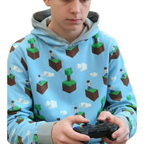 Child wearing a hoodie with a Minecraft pattern, holding a gaming controller.