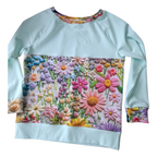 Light green sweatshirt with colorful floral pattern 