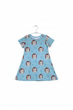 A light green short-sleeve baby dress with an all-over print of cute cartoon hedgehogs, flowers, rainbows, and small plants, shown flat against a white background.