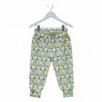 A pair of children's jogger pants featuring an all-over lemon and green leaf pattern on a white background, shown flat against a white backdrop.