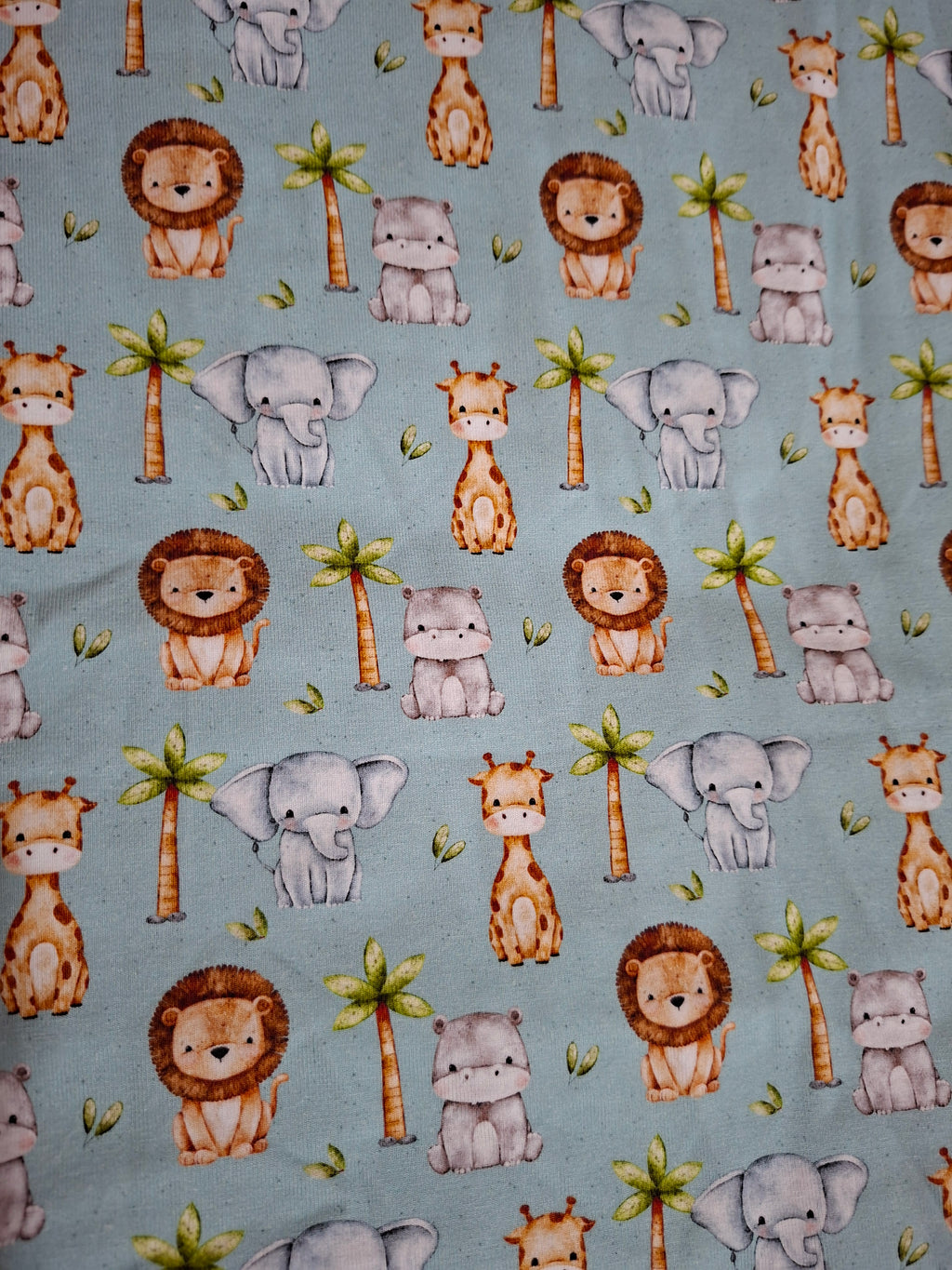 Pattern of cartoon animals on a mint green background