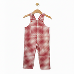 A baby romper in a red and white gingham check pattern, hanging on a wooden hanger against a plain white background. Snazzy Sproglets