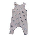 A baby romper in a light dusty pink color, featuring an all-over print of small black and white zebras. 