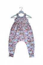 A baby romper with a light pink and white floral print featuring pumpkins, flowers, and leaves, shown flat against a white background.