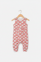 A pink sleeveless baby romper with an all-over white santa faces, hanging on a wooden hanger against a light gray background. Snazzy Sproglets