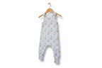 A sleeveless baby jumpsuit with an allover sheep and wildflower print on a light blue-gray background, featuring adjustable shoulder straps and cuffed legs. snazzy sproglets