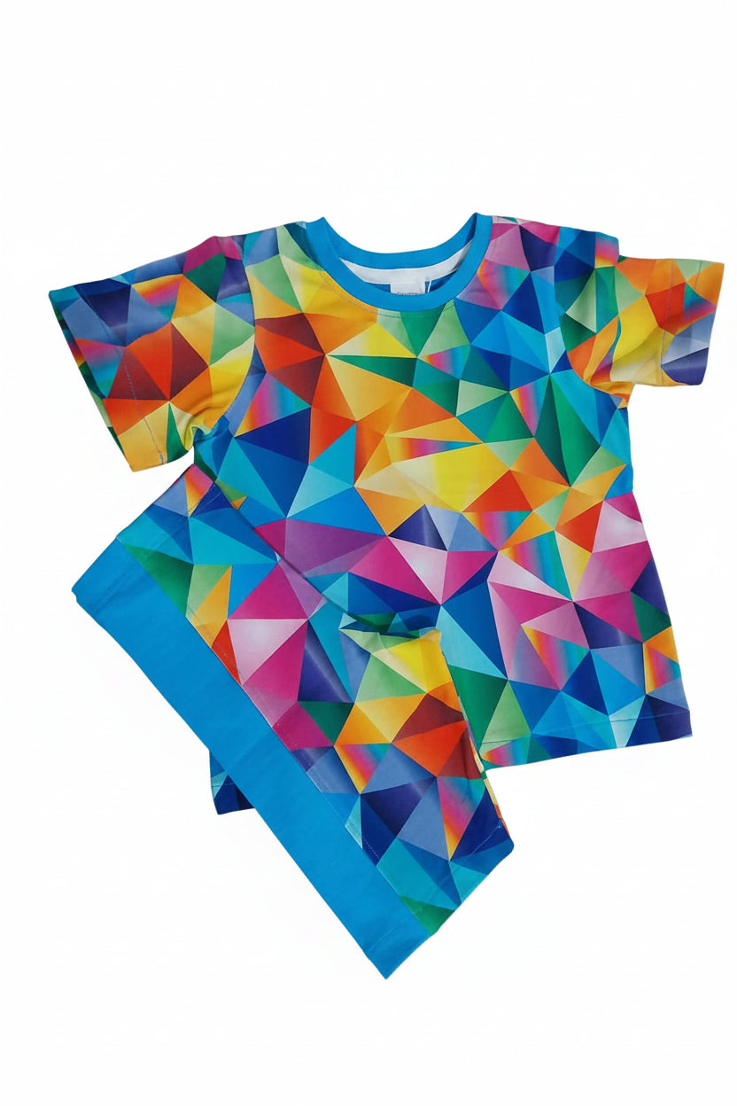 A two-piece kids'et featuring a short-sleeve top and matching pants with a vibrant geometric triangle pattern in multiple colors, laid flat on a gray carpet.