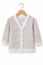 A baby cardigan sweater with a beige and off-white leopard print pattern, featuring a button-up front and ribbed trim.